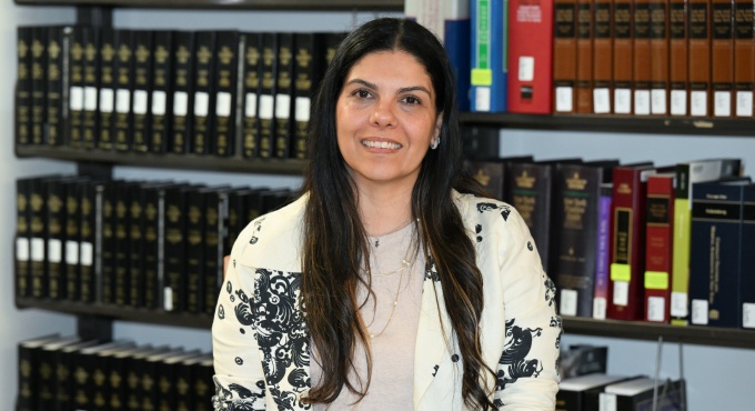 Woman sitting at a table in the law library. 
