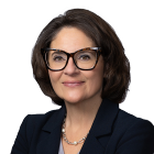 Woman smiling, wear black blazer and glasses. 