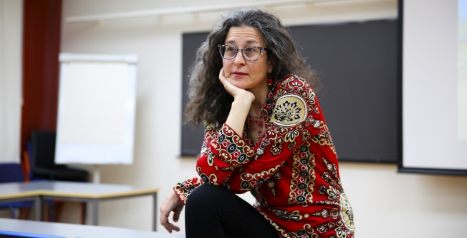 Braverman in front of a classroom, giving a lecture. 