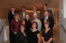 Class of 1990 gathered together, smiling. 