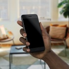 photo of a hand holding up a mobile phone. 