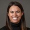 photo of smiling woman wearing black sweater. 