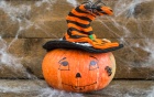pumpkin with a painted face and witches hat. 