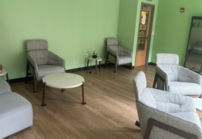 room with chairs, wooden floors. 