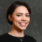 Professional portrait of Isabela (Isa) Budelmann wearing a black top.
