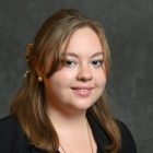 Professional portrait of Paige Wolf.