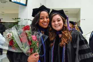 two UB Law graduates smiling for photo. 